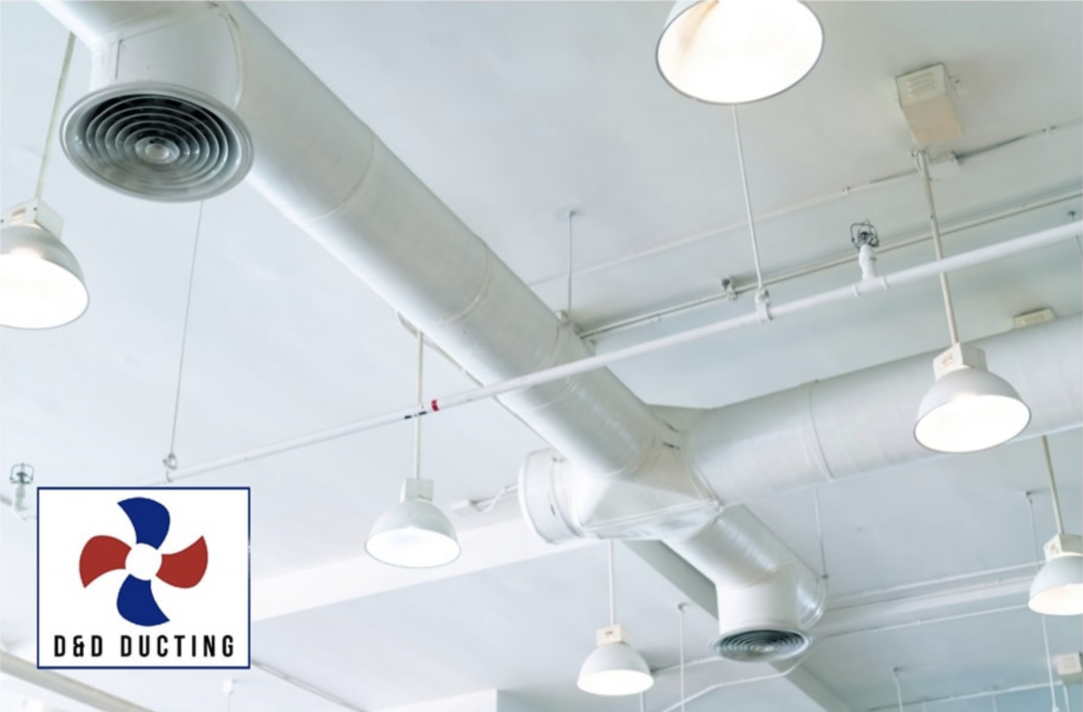 Clean white ceiling ductwork and diffusers in a commercial interior